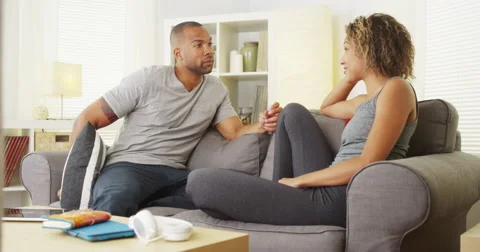 Black couple having a conversation in their living room Video stock 44498413