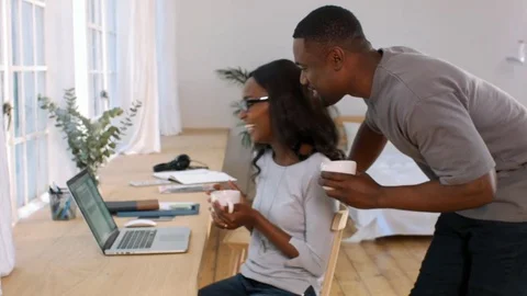 Black couple looking at computer screen at home Stock Footage 77509596