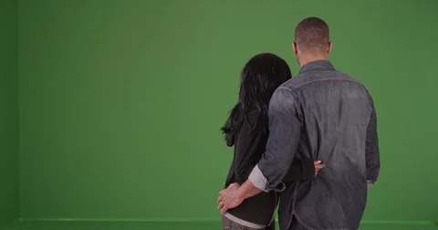 Black couple spots something beautiful while they are walking on green screen Stock-Footage 79267716