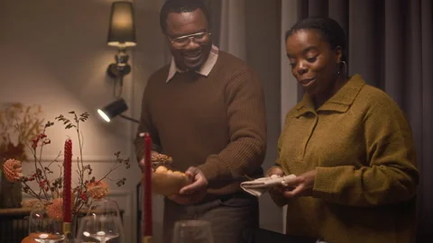 Black Couple Talking and Setting Table for Thanksgiving Day Celebration Stock Footage 320602173