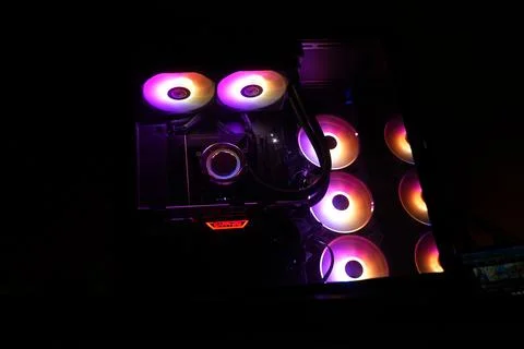 A black CPU casing with rgb fans in a dark room Stock Photos