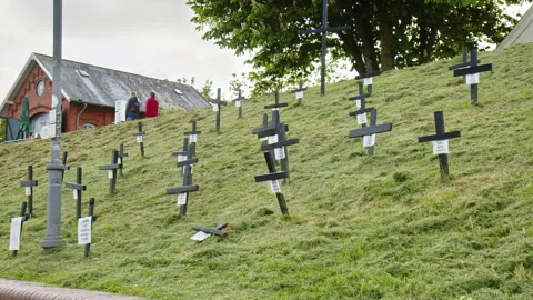 Black Crosses on a Dike in the Harbor of Greetsiel as a silent protest by the Stock Footage 243438576
