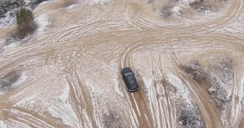 A black crossover rides a sand pit. Black SUV off-road. Video stock 144875755