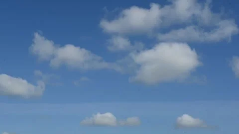 Black Crow Flying Across Blue Sky With Clouds – Horizontal Stock Footage 334310686