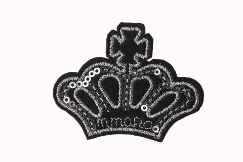 Black crown embroidered patch with silver sequins isolated on white background Fotos de archivo