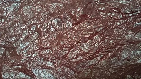 Black crumpled plastic bag texture background rotating. HDPE Polyethylene Stock Footage 316377540