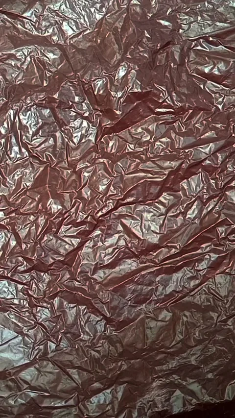 Black crumpled plastic bag texture background rotating. HDPE Polyethylene Stock Footage 316377670