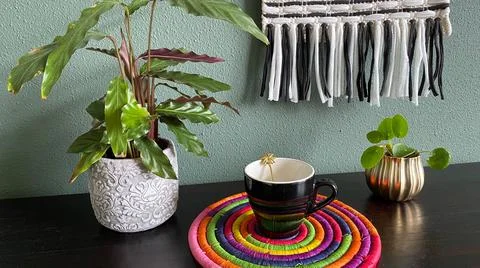 Black Cup Of Coffee Colored Coaster With Plants Stock Photos