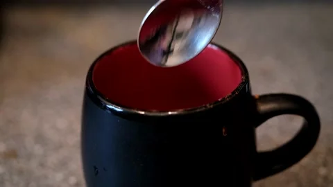 Black cup into which instant coffee is poured and filled with water Video stock 168411682
