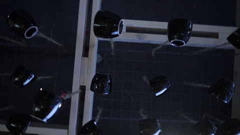 Black cups hang from the ceiling. Camera braceletsa clockwise Stock Footage 122396999