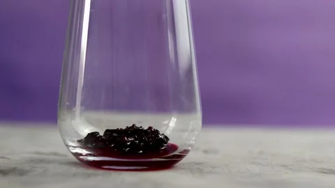 Black currant falls into a glass. Stock Footage 155983112