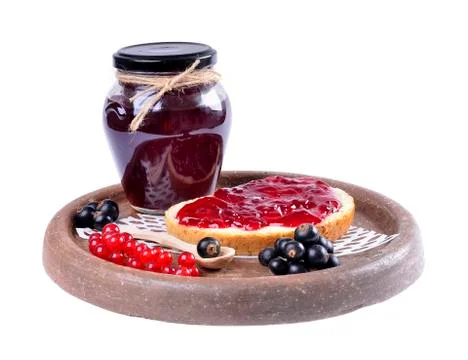 Black currant jam on a slice and in a jar,isolated on white background. Stock Photos