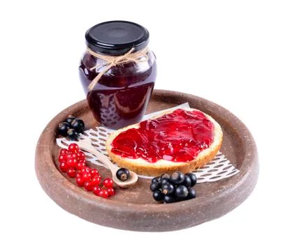 Black currant jam on a slice and in a jar,isolated on white background. Stock Photos