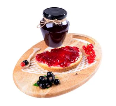 Black currant jam on a slice and in a jar,isolated on white background. Stock Photos