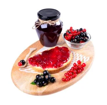 Black currant jam on a slice and in a jar,isolated on white background. Stock Photos
