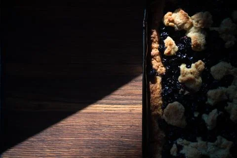 Black currant pie on a baking sheet, shortcrust pastry, low key Stock Photos