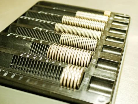 Black currency sorting tray filled with organised piles of coins Stock Photos