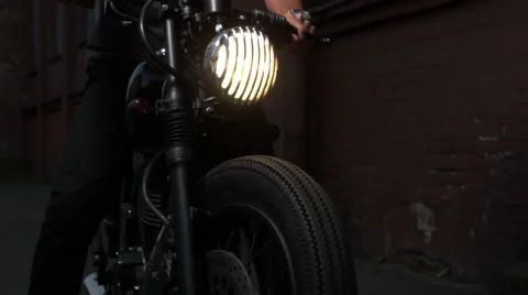 Black custom made cafe racer motorcycle bike. Handsome man sitting on a motor Stock Footage 61327779