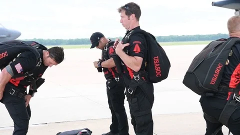 Black Daggers parachutists securing their kit prior to boarding C-130 Hercules Stock Footage 108312317