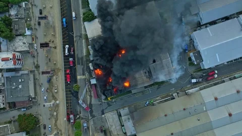 Black dark some of Burning building rising into sky. Fire in warehouse Stock Footage 282696523