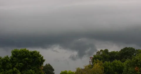Black dark stormy clouds in the sky above a tree line ready for a thunderstorm Video stock 207927774