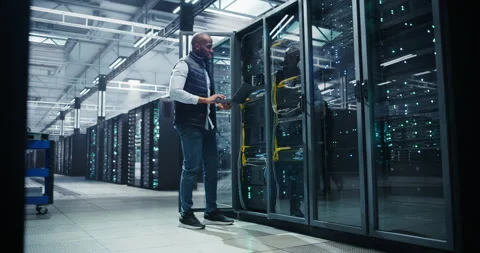 Black Data Center Engineer Using Laptop Computer Stock Footage 320866960
