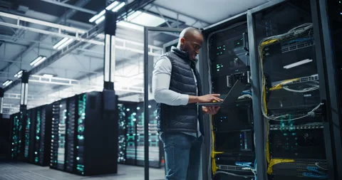 Black Data Center Engineer Using Laptop Computer Stock Footage 320867091