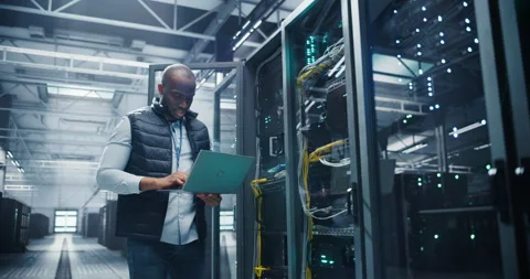 Black Data Center Engineer Using Laptop Computer Stock Footage 320867094