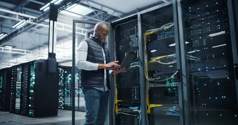 Black Data Center Engineer Using Laptop Computer Stock Footage 320867114