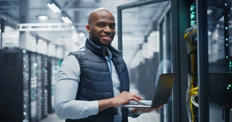 Black Data Center Engineer Using Laptop Computer Stock Footage 320867283