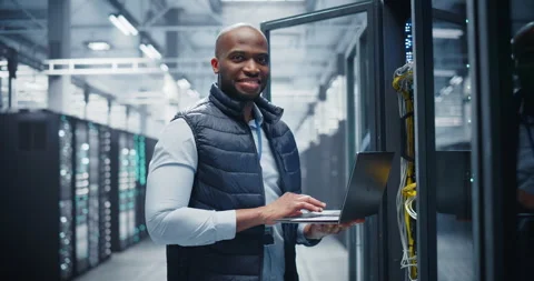 Black Data Center Engineer Using Laptop Computer Stock Footage 320867289