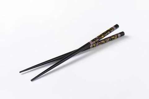 Black decorative chopsticks with gold pattern Stock Photos