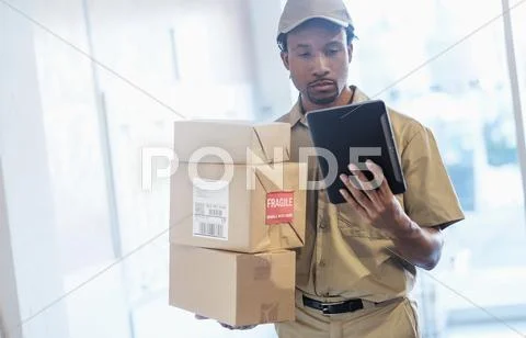 Black Delivery Man Using Digital Tablet