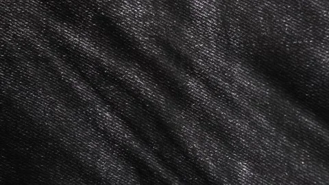 Black denim, jean fabric cloth background. Fashion, modern dress material. Stock Footage 147222953