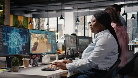 Black designer using AI deep learning system and architectural software Stock Photos