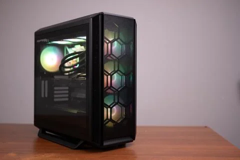 Black desktop computer case for gamers with RGB backlight standing on a desk Foto stock