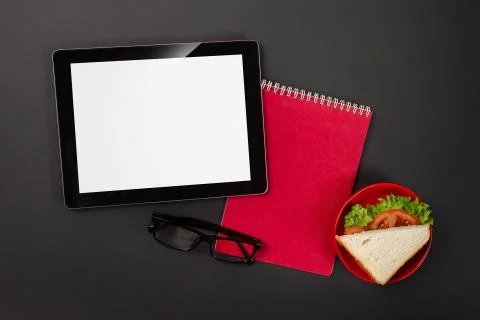 On a black desktop tablet pad notepad with a place for your inscription. Stock Photos