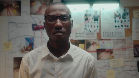 Black Detective Posing on Camera in Office at Night Stock Footage 239034700