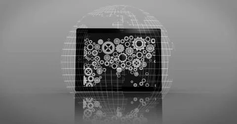 Black device displaying white gear icons forming world map on shiny surface in Stock Photos
