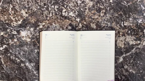Black diary on a black marble background Stock Footage 121315090