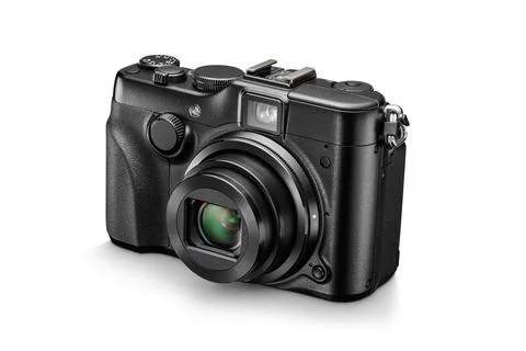 Black digital compact photo camera with open lens. Front view, isolated on .. Stock Photos