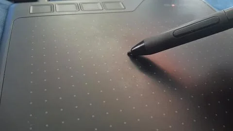 Black digital graphic drawing tablet with stylus pen for creative work Stock Photos