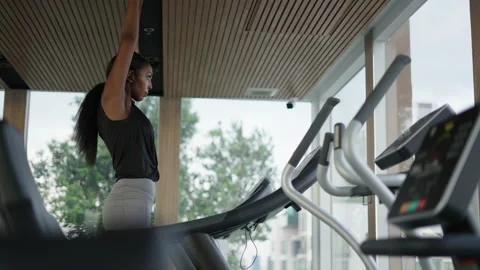 Black digital nomad stretching in a treadmill looking the skyline through a Stock Footage 232581037