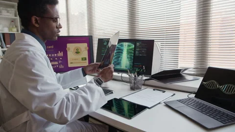Black Doctor Interpreting X ray Using Smart Technology on Computer Stock Footage 332360572
