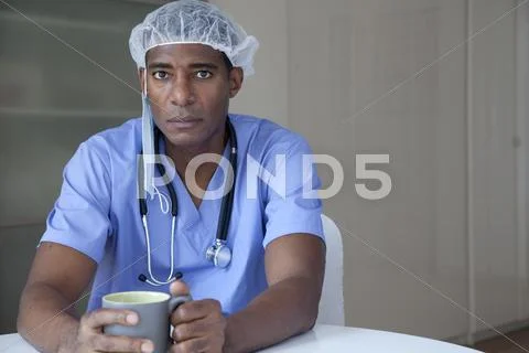 Black Doctor In Scrubs And Surgical Cap