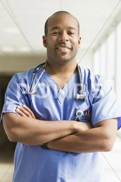 Black Doctor Standing With Arms Crossed