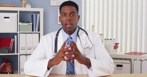 Black doctor talking to camera in video chat Video stock 42667228