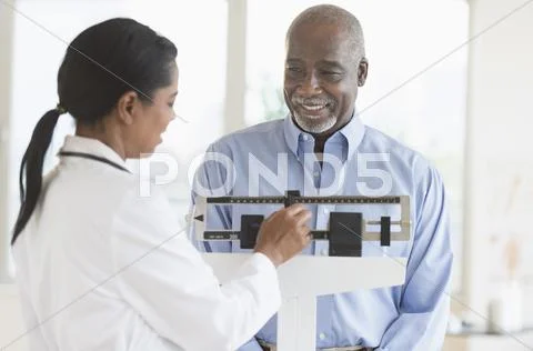 Black Doctor Weighing Patient