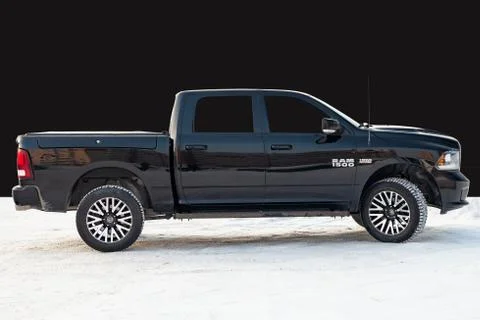 Black Dodge Ram with an engine of 5.7 liters side view on the background of b Stock Photos