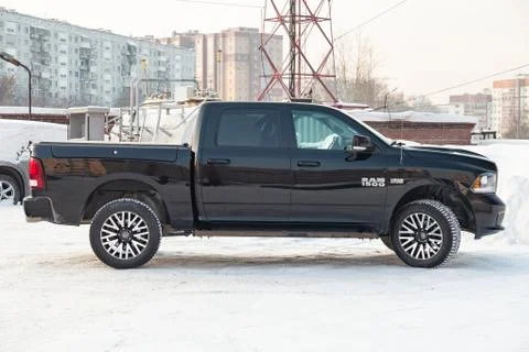 Black Dodge Ram with an engine of 5.7 liters front view on the car parking wi Stock Photos